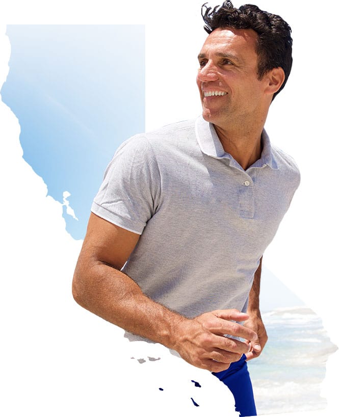 Man running on beach with California state cutout