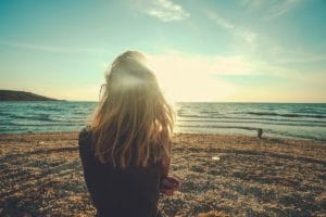 woman at beach thinking about cognitive behavioral therapy for addiction