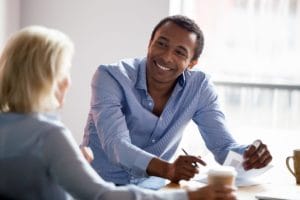 smiling man at work after going to Oceanfront Recovery's hallucinogen addiction treatment center