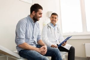 man conferring with doctor about oxycontin addiction treatment center