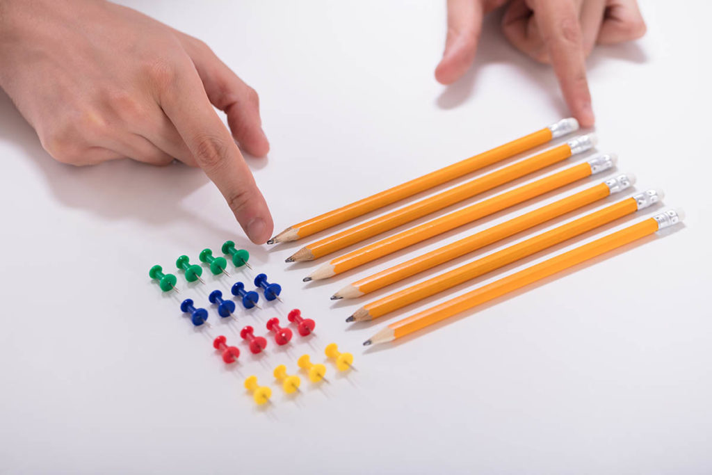 person organizing pencils and push pins, living with ocd