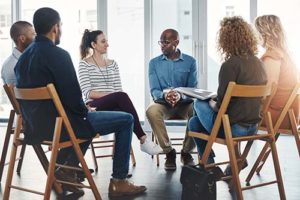 A coed rehab group discussing together